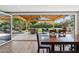 Backyard view from dining area with sliding doors to covered patio, seating, and garden at 5339 E Osborn Rd, Phoenix, AZ 85018