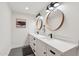 Bright bathroom features double vanity, modern fixtures, round mirrors, and beautiful quartz countertop at 5339 E Osborn Rd, Phoenix, AZ 85018
