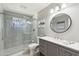 Updated bathroom with a glass enclosed shower and updated vanity with quartz counters and a decorative mirror at 5339 E Osborn Rd, Phoenix, AZ 85018