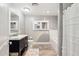 Bright bathroom featuring a gray vanity, bathtub, white subway tile, and wood look floors at 5339 E Osborn Rd, Phoenix, AZ 85018