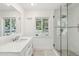 Bright bathroom showcasing a single vanity with quartz counters, large mirror and glass enclosed shower at 5339 E Osborn Rd, Phoenix, AZ 85018