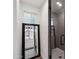 Bathroom featuring updated tiled shower, with a decorative mirror showing the vanity and updated lighting at 5339 E Osborn Rd, Phoenix, AZ 85018
