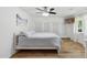 Bright bedroom features a ceiling fan, a large bed, wood floors, and built-in cabinets with custom hardware at 5339 E Osborn Rd, Phoenix, AZ 85018