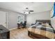 Bedroom features hardwood floors, a ceiling fan, desk, and a large bed with modern decor at 5339 E Osborn Rd, Phoenix, AZ 85018