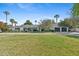 Charming single-story home featuring a spacious lawn, mature palm trees, and a three-car garage at 5339 E Osborn Rd, Phoenix, AZ 85018