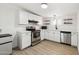 Bright kitchen with white cabinetry, stainless steel appliances, and modern countertops at 5339 E Osborn Rd, Phoenix, AZ 85018