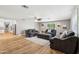 Large living room featuring hardwood floors, gray sofas, and bright natural light at 5339 E Osborn Rd, Phoenix, AZ 85018
