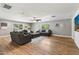 Spacious living room with hardwood floors, three sofas, a ceiling fan, and large windows at 5339 E Osborn Rd, Phoenix, AZ 85018