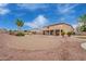 Expansive backyard with sand pit, desert landscaping, covered patio, and two story home at 5510 N 132Nd Dr, Litchfield Park, AZ 85340