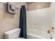 Bathroom featuring a tub with shower, gray textured walls, and a shower curtain at 5510 N 132Nd Dr, Litchfield Park, AZ 85340
