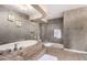 Luxurious bathroom showcasing a jetted tub and a glass-enclosed shower at 5510 N 132Nd Dr, Litchfield Park, AZ 85340
