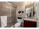 Bathroom featuring a shower behind glass, granite counters, and a vanity with cherry stained wood at 5510 N 132Nd Dr, Litchfield Park, AZ 85340