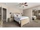 Bedroom featuring a large bed, mirrored closet, ceiling fan, and a neutral color palette at 5510 N 132Nd Dr, Litchfield Park, AZ 85340