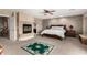 Comfortable bedroom with fireplace, plush carpet, and natural lighting at 5510 N 132Nd Dr, Litchfield Park, AZ 85340