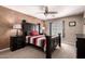 Bedroom features a black wooden bed frame, ceiling fan, and neutral colored walls at 5510 N 132Nd Dr, Litchfield Park, AZ 85340