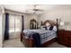 Comfortable bedroom features a ceiling fan, traditional decor, and plenty of natural light at 5510 N 132Nd Dr, Litchfield Park, AZ 85340
