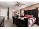 Bedroom featuring a black wooden bed frame, ceiling fan, mirrored closet, and neutral walls at 5510 N 132Nd Dr, Litchfield Park, AZ 85340