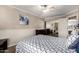 Comfortable bedroom features a ceiling fan, dresser and mirrored closet at 5510 N 132Nd Dr, Litchfield Park, AZ 85340