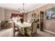 Elegant dining room featuring a decorative chandelier, window treatments, and classic furnishings at 5510 N 132Nd Dr, Litchfield Park, AZ 85340