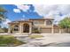 Beautiful two-story home featuring a three-car garage and a well-manicured front yard on a sunny day at 5510 N 132Nd Dr, Litchfield Park, AZ 85340