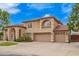 Attractive home exterior featuring lush landscaping, mature trees, and a convenient three-car garage with ample driveway space at 5510 N 132Nd Dr, Litchfield Park, AZ 85340