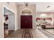 Elegant foyer with high ceilings, decorative chandelier, rich double door entrance, and views into the formal living space at 5510 N 132Nd Dr, Litchfield Park, AZ 85340