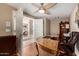 This light and airy home office features a ceiling fan and built-in bookcase at 5510 N 132Nd Dr, Litchfield Park, AZ 85340