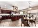 Spacious kitchen featuring a large island, dark wood cabinetry, and stainless steel appliances at 5510 N 132Nd Dr, Litchfield Park, AZ 85340