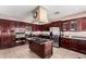 Modern kitchen with a center island cooktop, stainless steel appliances, and dark wood cabinetry at 5510 N 132Nd Dr, Litchfield Park, AZ 85340