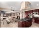 Open-concept kitchen with a central island, stainless steel appliances, and a connecting breakfast nook at 5510 N 132Nd Dr, Litchfield Park, AZ 85340