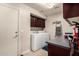 Well-lit laundry room with washer, dryer, storage cabinets, and convenient counter space at 5510 N 132Nd Dr, Litchfield Park, AZ 85340