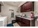 This laundry room features dark wood cabinets and ample counter space at 5510 N 132Nd Dr, Litchfield Park, AZ 85340