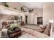 Open living room with high ceilings, unique architectural details, comfortable seating, and views into adjacent dining and living areas at 5510 N 132Nd Dr, Litchfield Park, AZ 85340
