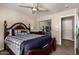 A spacious main bedroom includes a ceiling fan, a double mirrored closet and an open doorway at 5510 N 132Nd Dr, Litchfield Park, AZ 85340