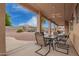 Covered patio with ceiling fan overlooking an inviting backyard with a pool and mature landscaping at 5510 N 132Nd Dr, Litchfield Park, AZ 85340