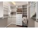 Well-designed walk-in closet featuring custom shelving and storage drawers at 5510 N 132Nd Dr, Litchfield Park, AZ 85340