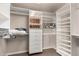 Organized walk-in closet with custom shelving and ample storage space at 5510 N 132Nd Dr, Litchfield Park, AZ 85340