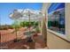 Inviting backyard patio features a table, umbrella, and rock landscaping at 5830 E Mckellips Rd # 2, Mesa, AZ 85215