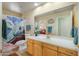 Bathroom with vanity, large mirror, and bathtub with shower curtain and mountain motif at 5830 E Mckellips Rd # 2, Mesa, AZ 85215