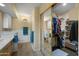 Bright bathroom features a tiled floor, a vanity, and a mirror-door closet with storage at 5830 E Mckellips Rd # 2, Mesa, AZ 85215
