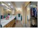 Bright bathroom features a tiled floor, a vanity, and a mirror-door closet with storage at 5830 E Mckellips Rd # 2, Mesa, AZ 85215