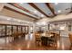 Spacious dining area with wood floors, exposed beams, and outdoor patio access at 5830 E Mckellips Rd # 2, Mesa, AZ 85215