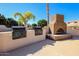 Community outdoor barbecue area with built-in grills and a brick fireplace at 5830 E Mckellips Rd # 2, Mesa, AZ 85215