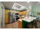 Bright kitchen features stainless steel appliances, an island with seating, and ample counter space at 5830 E Mckellips Rd # 2, Mesa, AZ 85215