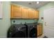 Well-equipped laundry room with washer, dryer, and storage cabinets at 5830 E Mckellips Rd # 2, Mesa, AZ 85215