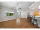 Open-concept living area with hardwood floors, high ceilings, and a breakfast bar, creating a seamless flow for entertaining at 5830 E Mckellips Rd # 2, Mesa, AZ 85215