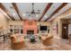 Cozy living room boasts a fireplace, wood beams, and comfortable seating for relaxation at 5830 E Mckellips Rd # 2, Mesa, AZ 85215