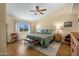 Comfortable main bedroom with a ceiling fan, wood floors, and an abundance of natural light at 5830 E Mckellips Rd # 2, Mesa, AZ 85215