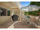 Relaxing covered patio area with outdoor seating, a grill, and views of the backyard at 5830 E Mckellips Rd # 2, Mesa, AZ 85215