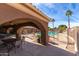 Covered patio with tables and chairs overlooking a gated community pool and desert landscaping at 5830 E Mckellips Rd # 2, Mesa, AZ 85215